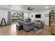 Bright living room with modern furnishings, a ceiling fan, and a large window with a neighborhood view at 5112 E Cholla St, Scottsdale, AZ 85254