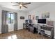 Home office featuring two workstations, wood-look flooring, and a stylish ceiling fan at 5112 E Cholla St, Scottsdale, AZ 85254