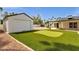 Backyard featuring a putting green, storage shed and covered patio at 5827 E Larkspur Dr, Scottsdale, AZ 85254