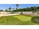 Inviting backyard featuring a putting green, pool, and lush landscaping, perfect for outdoor relaxation and entertainment at 5827 E Larkspur Dr, Scottsdale, AZ 85254