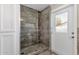 Bathroom includes a glass door shower, stone tile and an exterior door at 5827 E Larkspur Dr, Scottsdale, AZ 85254