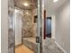Modern shower with neutral tile, a glass door, and a built-in bench for a luxurious bathing experience at 5827 E Larkspur Dr, Scottsdale, AZ 85254