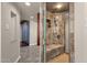 Bathroom with a glass enclosed shower featuring stone tile and a built-in bench at 5827 E Larkspur Dr, Scottsdale, AZ 85254