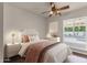 Cozy bedroom with a ceiling fan, window and comfortable furnishings at 5827 E Larkspur Dr, Scottsdale, AZ 85254