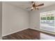 Bedroom with a ceiling fan, hardwood floors and large window view to the exterior at 5827 E Larkspur Dr, Scottsdale, AZ 85254