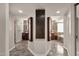 Hallway leading to and vanities and ensuite bathroom with natural lighting in updated home at 5827 E Larkspur Dr, Scottsdale, AZ 85254