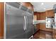 Large stainless steel refrigerator and modern kitchen appliances including a dishwasher, sink, and cooktop at 5827 E Larkspur Dr, Scottsdale, AZ 85254