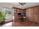 Home office with custom built-in wooden cabinets, shelves, and hardwood flooring at 5827 E Larkspur Dr, Scottsdale, AZ 85254