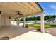 Large covered patio with ceiling fans overlooking putting green and pool at 5827 E Larkspur Dr, Scottsdale, AZ 85254