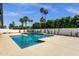 Sparkling swimming pool surrounded by lush landscaping and clear blue skies at 5827 E Larkspur Dr, Scottsdale, AZ 85254