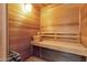 Relaxing sauna with wooden benches, a bucket, and a heater for a spa-like experience at 5827 E Larkspur Dr, Scottsdale, AZ 85254