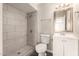 Bathroom featuring a tile shower, toilet, sink with mirror and vanity at 6139 N 31St Dr, Phoenix, AZ 85017