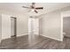 Spacious bedroom with wood flooring, ceiling fan, and connecting bathroom at 6139 N 31St Dr, Phoenix, AZ 85017