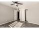 A light-filled bedroom features gray walls and floors, closet and ceiling fan at 6139 N 31St Dr, Phoenix, AZ 85017