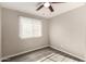 Standard bedroom with updated flooring, ceiling fan and view at 6139 N 31St Dr, Phoenix, AZ 85017