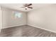 Cozy bedroom with ceiling fan, window view, and wood floors at 6139 N 31St Dr, Phoenix, AZ 85017
