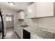 Bright kitchen with white cabinets, stainless steel sink and black appliances at 6139 N 31St Dr, Phoenix, AZ 85017