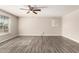 Open living room featuring wood-look flooring, a ceiling fan and light-filled windows at 6139 N 31St Dr, Phoenix, AZ 85017