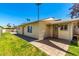 A well-kept backyard with a grassy area and stone pathway offers a pleasant outdoor space for leisure and recreation at 630 E Jensen St # 154, Mesa, AZ 85203
