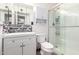 A bright bathroom features a glass-enclosed shower, modern vanity with a mirror, and a toilet at 630 E Jensen St # 154, Mesa, AZ 85203