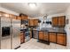 Efficient kitchen space with stainless steel appliances, dark countertops, and natural-toned cabinetry at 630 E Jensen St # 154, Mesa, AZ 85203