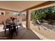 Covered backyard patio with table and seating setup for outdoor dining and entertaining at 6626 W Monona Dr, Glendale, AZ 85308