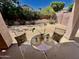 Charming backyard patio setup with table and chairs for outdoor dining at 6626 W Monona Dr, Glendale, AZ 85308
