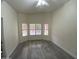 Empty bedroom with wood floors and bright windows with shutter style blinds at 6626 W Monona Dr, Glendale, AZ 85308