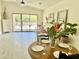 Dining area features a round table with a view to a fireplace and outside patio at 6626 W Monona Dr, Glendale, AZ 85308