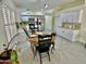 Open dining area with wood table and black chairs next to the kitchen with stainless appliances at 6626 W Monona Dr, Glendale, AZ 85308
