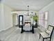 Bright dining room with rustic table, modern chandelier, and neutral decor at 6626 W Monona Dr, Glendale, AZ 85308