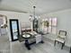 A dining room featuring wood-look tile, a modern chandelier, and decorative tables at 6626 W Monona Dr, Glendale, AZ 85308