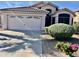 Charming home with a well-manicured front yard and a two-car garage featuring decorative windows at 6626 W Monona Dr, Glendale, AZ 85308