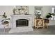 Bright fireplace with decor and adjacent rattan cabinet at 6626 W Monona Dr, Glendale, AZ 85308