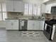 Modern kitchen featuring white cabinets, granite countertops, and stainless steel appliances at 6626 W Monona Dr, Glendale, AZ 85308