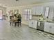 Bright eat-in kitchen features white cabinets, granite countertops, and a view of the dining and living spaces at 6626 W Monona Dr, Glendale, AZ 85308