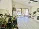 Bright living room featuring a fireplace, vaulted ceilings, and sliding doors to the backyard at 6626 W Monona Dr, Glendale, AZ 85308
