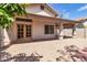 Home's backyard with covered patio, brick-laid patio floor, rock landscaping, and outdoor access at 6837 S Roosevelt St, Tempe, AZ 85283