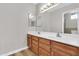 Bathroom with a double sink vanity, neutral wall color, and plenty of counter space at 6837 S Roosevelt St, Tempe, AZ 85283