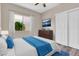 Cozy bedroom with a large window, closet, dresser, television, and a ceiling fan at 6837 S Roosevelt St, Tempe, AZ 85283