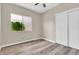 Bright bedroom featuring hardwood floors, a window with natural light, and a closet at 6837 S Roosevelt St, Tempe, AZ 85283