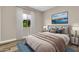 Bedroom features large window with white curtains and a comfortable bed with decorative pillows and throw at 6837 S Roosevelt St, Tempe, AZ 85283