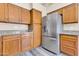 The kitchen features classic wooden cabinets, granite countertops, and stainless steel appliances at 6837 S Roosevelt St, Tempe, AZ 85283
