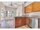 Kitchen featuring wooden cabinets, granite countertops, stainless steel appliances, with an adjacent dining space at 6837 S Roosevelt St, Tempe, AZ 85283