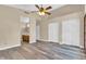 Spacious main bedroom with gray wood floors, closet, and access to an ensuite bathroom at 6837 S Roosevelt St, Tempe, AZ 85283