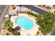 Aerial view of a community pool surrounded by lounge chairs, trees, and lush landscaping at 6837 S Roosevelt St, Tempe, AZ 85283