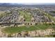 Expansive aerial view of a community built around a green golf course in the desert at 6847 S 27Th Pl, Phoenix, AZ 85042