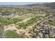 An aerial view of a golf course neighborhood with lush green fairways and desert landscape at 6847 S 27Th Pl, Phoenix, AZ 85042