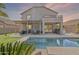 Backyard showcasing a pool, covered patio, lush landscaping, and a putting green at 6847 S 27Th Pl, Phoenix, AZ 85042