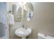 Powder bathroom featuring a pedestal sink, decorative mirrors, and neutral walls at 6847 S 27Th Pl, Phoenix, AZ 85042